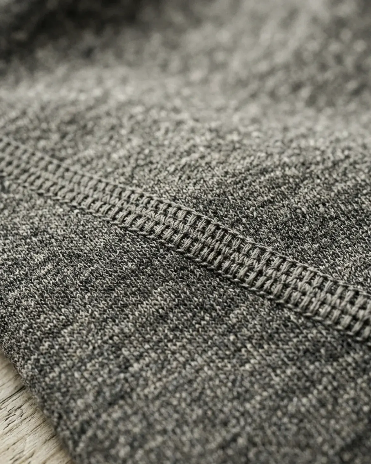 Flat-lock seam detail on heather grey cotton.